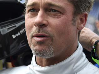 (FILES) This file photo taken on June 18, 2016 shows US actor Brad Pitt as he removes his helmet after a full lap on the Le Mans 24 Hours circuit with a Pescarolo Prototype driven by Austria's Alex Wurz, two-time winner and Grand Marshal for the 84th edition of the Le Mans 24 Hours endurance race in Le Mans, western France. Brad Pitt is under investigation by US authorities after being accused of physically and verbally abusing his children during an angry outburst, TMZ reported September 22, 2016. According to the entertainment news site the Los Angeles Police Department began probing Pitt based on an anonymous tip received by the LA County Department of Children and Family Services, as is systematic following any report of child abuse. / AFP PHOTO / JEAN-FRANCOIS MONIER