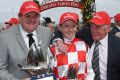 Jockey Stephen Baster poses with trainers Troy Corstens and Leon Corstens.