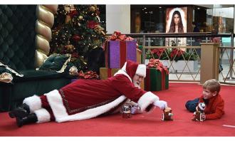 Santa playing on floor with li...