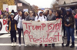 People protest on the University of Connecticut campus against the election of Republican Donald Trump as president Wednesday in Storrs, Conn.