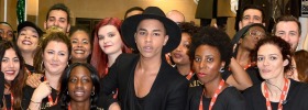 Designer Olivier Rousteing, centre, photographed here with H&M staff after launching his sell-out Balmain collection for ...