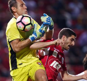 ADELAIDE, AUSTRALIA - NOVEMBER 11: Michael Theo of Brisbane Roar makes a save against Iacopo La Rocca of Adelaide United ...