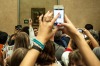 She's back there somewhere: crowds viewing the Mona Lisa at the Louvre.