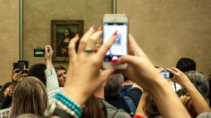 She's back there somewhere: crowds viewing the Mona Lisa at the Louvre.