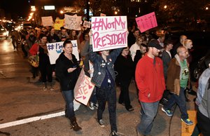 Protesters holds up signs in opposition of Donald Trump's presidential election victory as they march from Jefferson Square Park, Thursday, Nov. 10, 2016 in Louisville Ky.