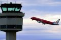 A plane takes off from Melbourne Airport, under the gaze of air traffic controllers.