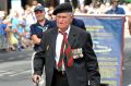 Ex-military soldier Graham Tweedale gets out of his wheelchair to march on Anzac Day 2016.