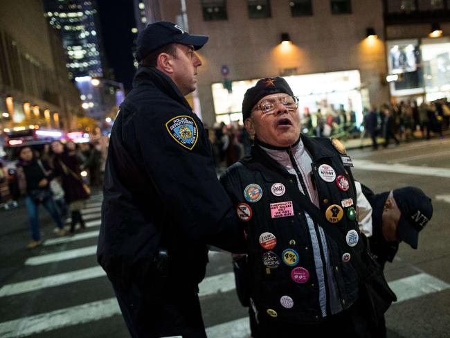 An anti-Donald Trump protester is arrested after marching in the street on Sixth Avenue in New York City. Picture: Drew Angerer.
