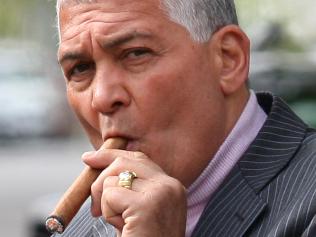 Mick Gatto in Carlton prior to the release of his autobiography. The Lord of Lygon Street Mick Gatto leans on his Mercedes smoking his favourite cigar.