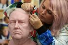 Sophie Crudgington inserts Yak hairs onto an unfinished wax figure of President-elect Donald Trump.