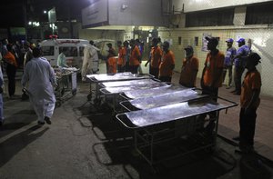 Staff members of a local hospital wait for casualties of a bomb blast at a Sufi shrine, in Karachi, Pakistan, Saturday, Nov. 12, 2016.