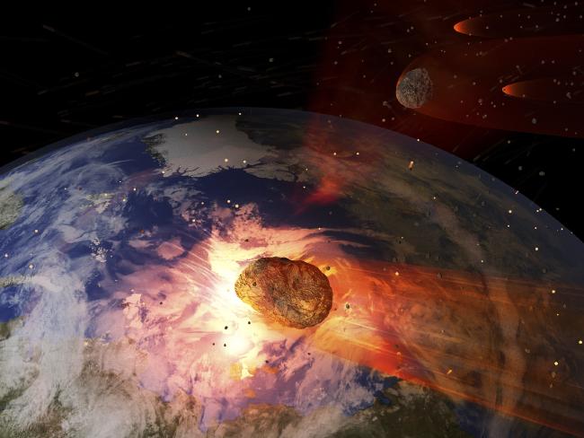 An illustration of a large asteroid impacting Earth which is believed to have wiped out the dinosaurs.