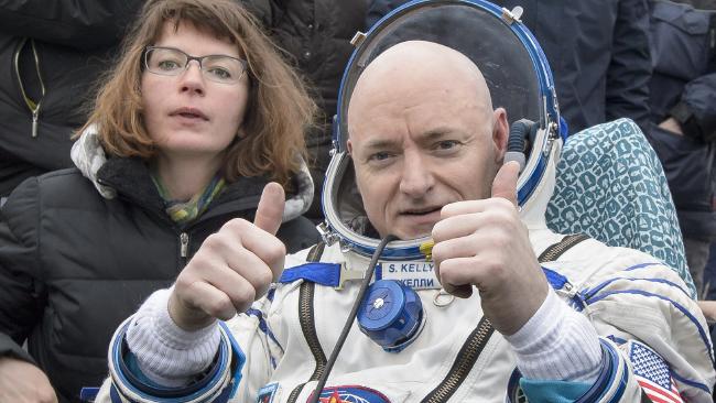 Commander Scott Kelly of NASA gives the thumbs up just minutes after returning to Earth with Russian cosmonaut Mikhail Kornienko. The pair completed an International Space Station record year-long mission to collect data on the effect of weightlessness on the human body to inform a future Mars mission. Picture: NASA/Bill Ingalls