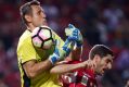 Brisbane's Michael Theo makes a save against Iacopo La Rocca of Adelaide United during their 1-1 draw.