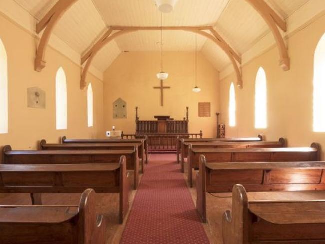 Built from locally sourced sandstone, the church also features high ceilings and arch windows. Picture: LJ Hooker