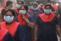 Women wear masks during an anti-pollution protest in New Delhi on Sunday.