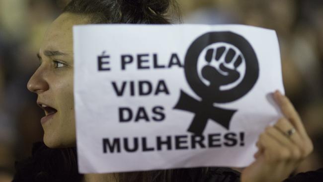 A sign reads “For the lives of women!” Picture: Leo Correa/AP