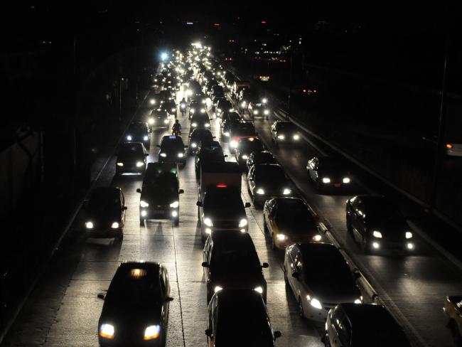 Motorists drive in the dark after the failure of electrical services the wake of the earthquake. Picture: AFP