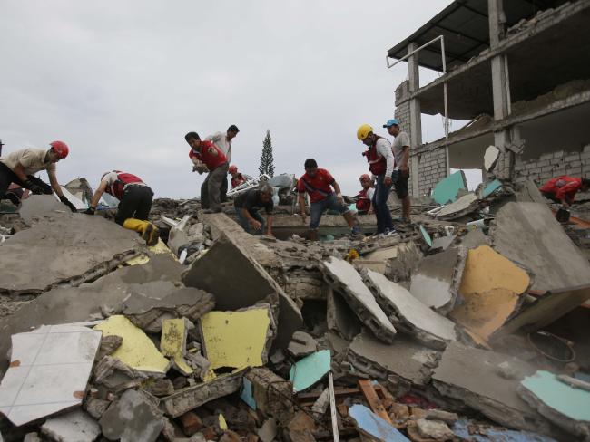 Volunteers search for survivors in the debris of buildings. Picture: AP Photo/Dolores Ochoa