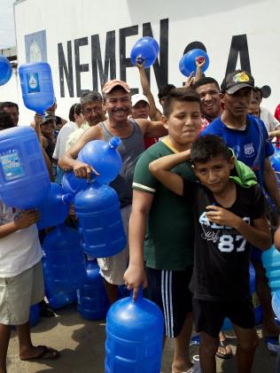 Residents stand in line as they wait to buy potable water in Manta, Ecuador. Picture: AP/Rodrigo Abd