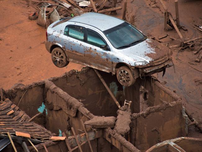 This car is perched on top of what was a house. Picture: Christophe Simon/AFP