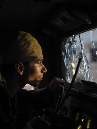 An Iraqi Counter Terrorism Section member advances on the eastern edge of Mosul. Picture: AFP/Bulent Kilic