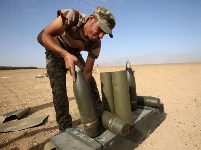 Shiite fighters from the Hashed al-Shaabi (Popular Mobilisation) prepare missiles to hit Islamic State positions. Picture: AFP/Ahmad Al-Rubaye