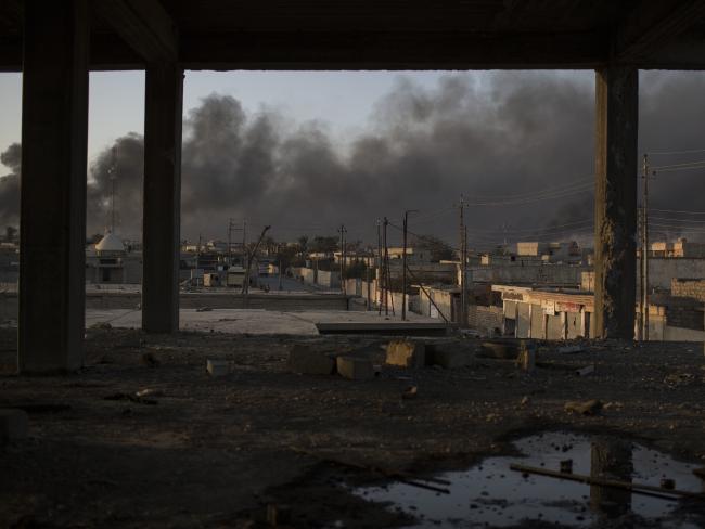 Smoke rises from burning oil fields in Qayara, some 50 kilometres south of Mosul. Picture: AP Photo/Felipe Dana