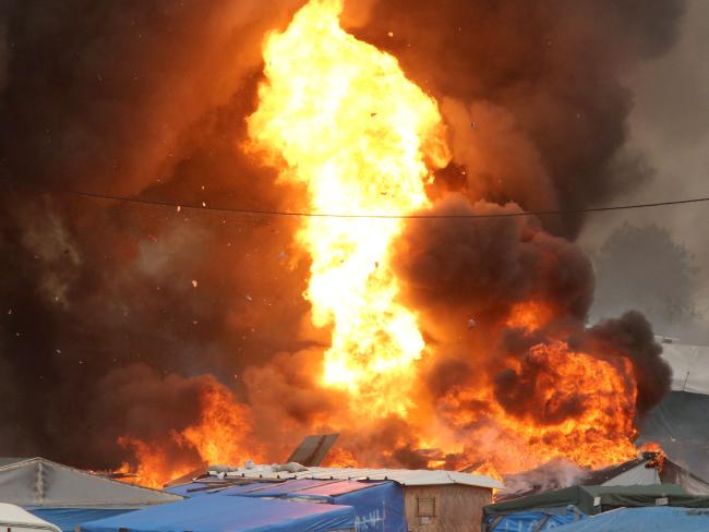 An explosion is seen at the &quot;jungle&quot; migrant camp in Calais, northern France. Picture: AFP