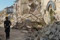 A man walks in a street in Amatrice, central Italy, where a 6.1 earthquake struck just after 3:30 a.m., Wednesday, Aug. ...
