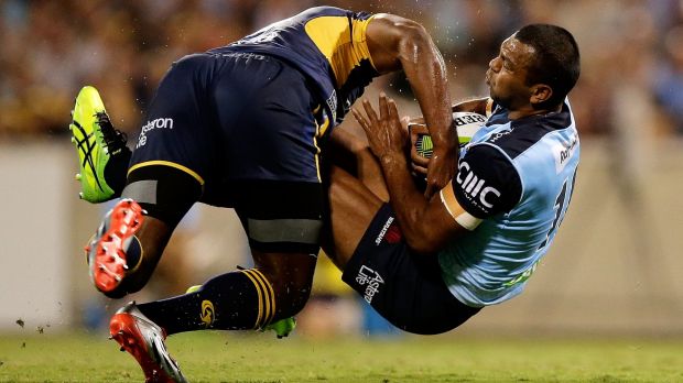 Down you go: Kurtley Beale of the Waratahs is upended by Tevita Kuridrani of the Brumbies.