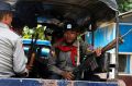 Myanmar police officers sit in a truck as they provide security in Maungdaw, Rakhine State, Myanmar.