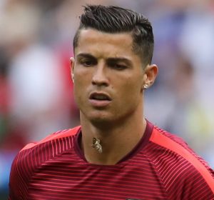 Moths fly around Portugal's Cristiano Ronaldo during warm up before the Euro 2016 final soccer match between Portugal ...