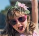 Little girl having fun at the beach in a sunny day Being playful, for Daily Life article?