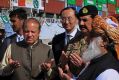 Pakistan's Prime Minister Nawaz Sharif, center left, and Army Chief General Raheel Sharif, fourth right, pray after ...