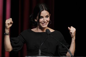 Courteney Cox gestures as she accepts the Lucy Award for Excellence in Television at the Crystal Lucy Awards on Tuesday June 1, 2010, in Los Angeles.