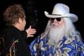 Elton John, left, greets Leon Russell on the stage during their joint concert at the Hollywood Palladium in Los Angeles. ...