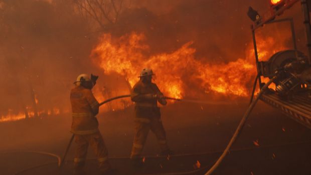 Firefighters face strong winds fanning an out of control fire in Sydney's west.