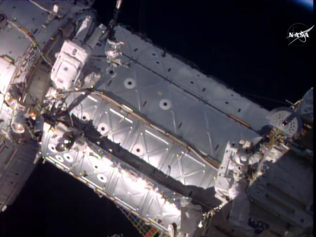 American astronauts Jeffrey Williams, left, and Kate Rubins taking a space walk to hook up a docking port outside the International Space Station. Source: AP