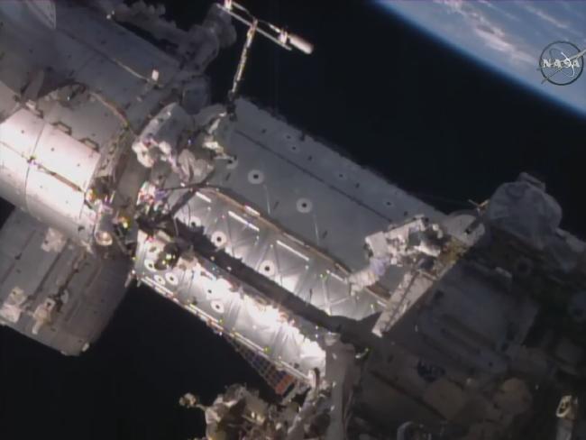 Kate Rubins, right, and Jeff Williams viewed near the docking port. Source: AFP