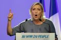 France's far-right National Front leader Marine Le Pen speaks behind the slogan "In the name of the people".