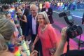 Prime Minister Malcolm Turnbull and his wife, Lucy, greet revellers on Oxford Street during this year's Mardi Gras parade.