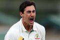 Mitchell Starc celebrates a wicket.