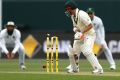 David Warner is bowled by Kyle Abbott of South Africa during day three of the Second Test between Australia and South ...