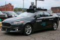 A self driving Uber car drives down River Road on Pittsburgh's Northside.