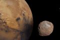 A representation of Mars with its small moons, Deimos and Phobos.