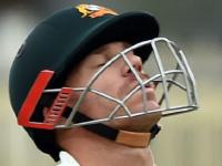 Australia's batsman David Warner reacts as he is b