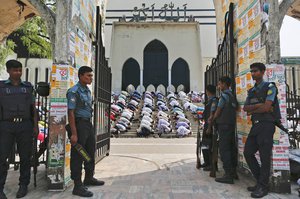 File - Bangladeshi policemen stand guard outside Bangladesh national mosque as members of various Islamic political groups and other Muslims attend Friday prayers before a protest in Dhaka, Bangladesh, Friday, March 25, 2016.