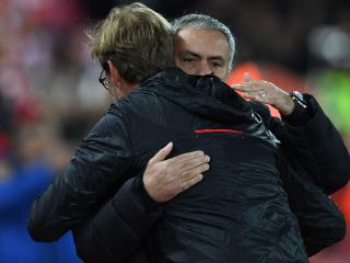 Liverpool's German manager Jurgen Klopp greets Manchester United's Portuguese manager Jose Mourinho (R) ahead of the English Premier League football match between Liverpool and Manchester United at Anfield in Liverpool, north west England on October 17, 2016. / AFP PHOTO / Paul ELLIS / RESTRICTED TO EDITORIAL USE. No use with unauthorized audio, video, data, fixture lists, club/league logos or 'live' services. Online in-match use limited to 75 images, no video emulation. No use in betting, games or single club/league/player publications. /