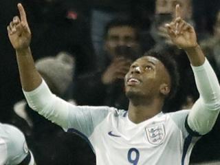 England's Daniel Sturridge, right, celebrates with England's Raheem Sterling, left, after scoring his side's first goal during the World Cup group F qualifying soccer match between England and Scotland at the Wembley stadium, London, Friday, Nov. 11, 2016. (AP Photo/Matt Dunham)